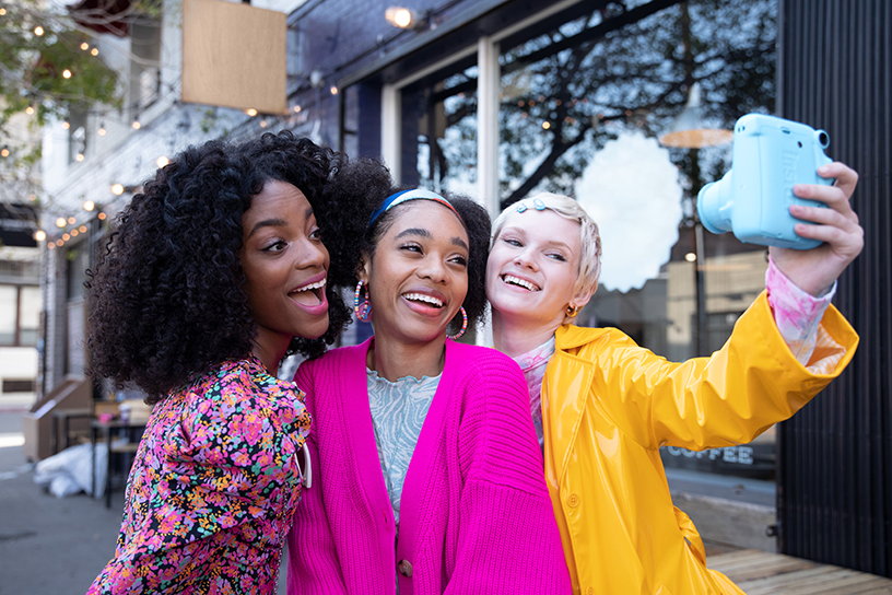 [photo] Three women taking group selfie photo with Sky Blue instax mini 11 camera outside on city street