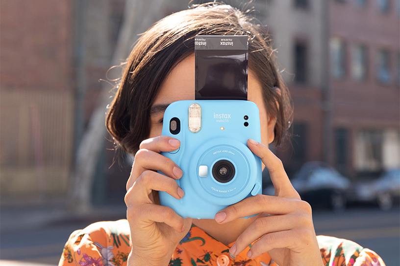 [photo] Woman looking through Sky Blue instax mini 11 and taking picture